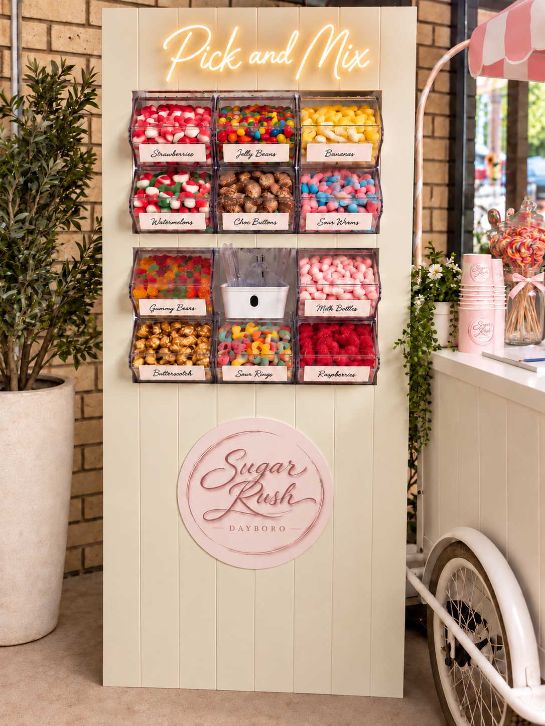 Sugar Rush Pick and Mix lolly wall with ten bins of lollies and a neon sign