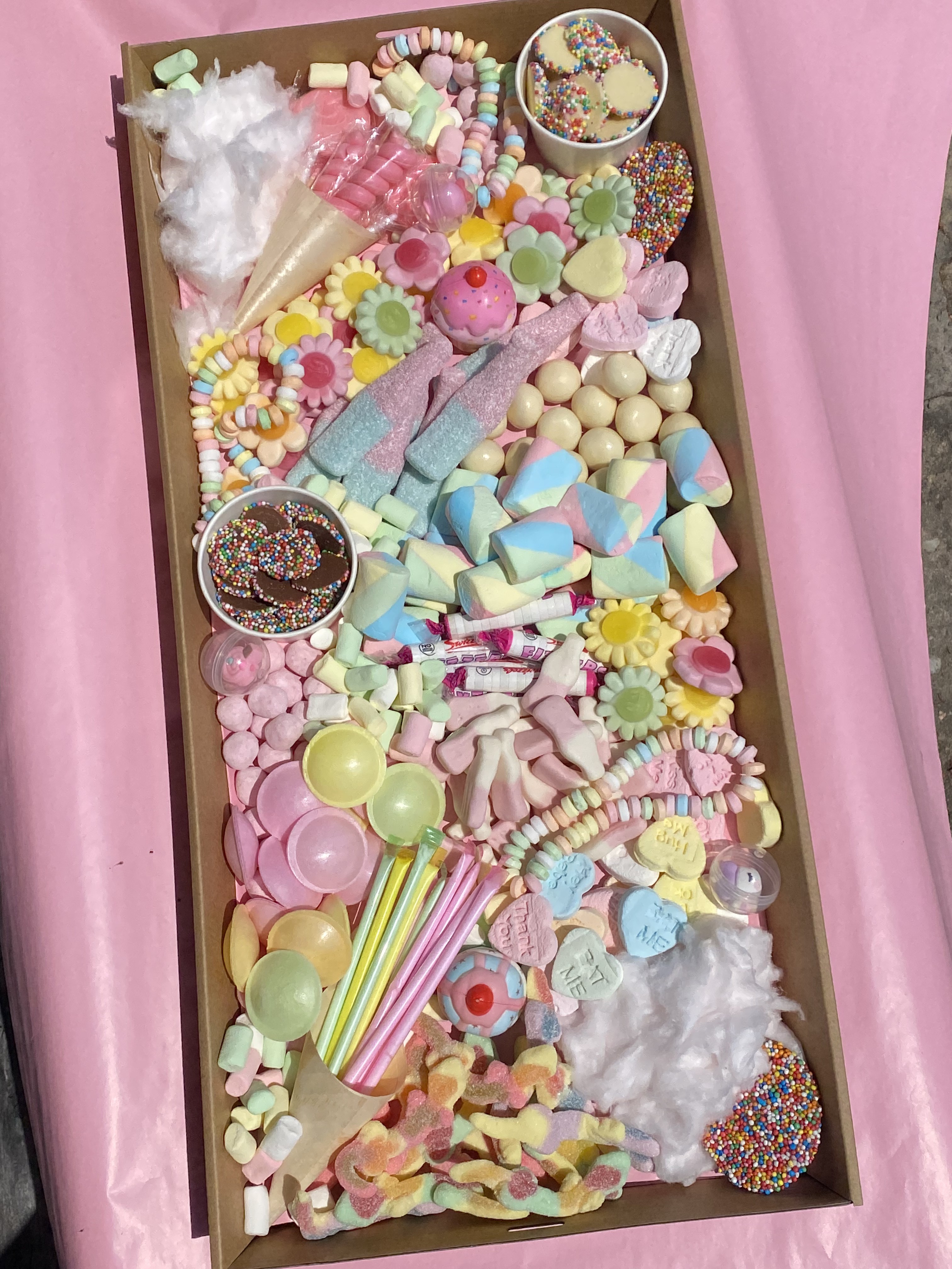 Luxury corporate gift box filled with assorted chocolates, sweet treats and a vanilla caramel room spray, tied with a gold ribbon